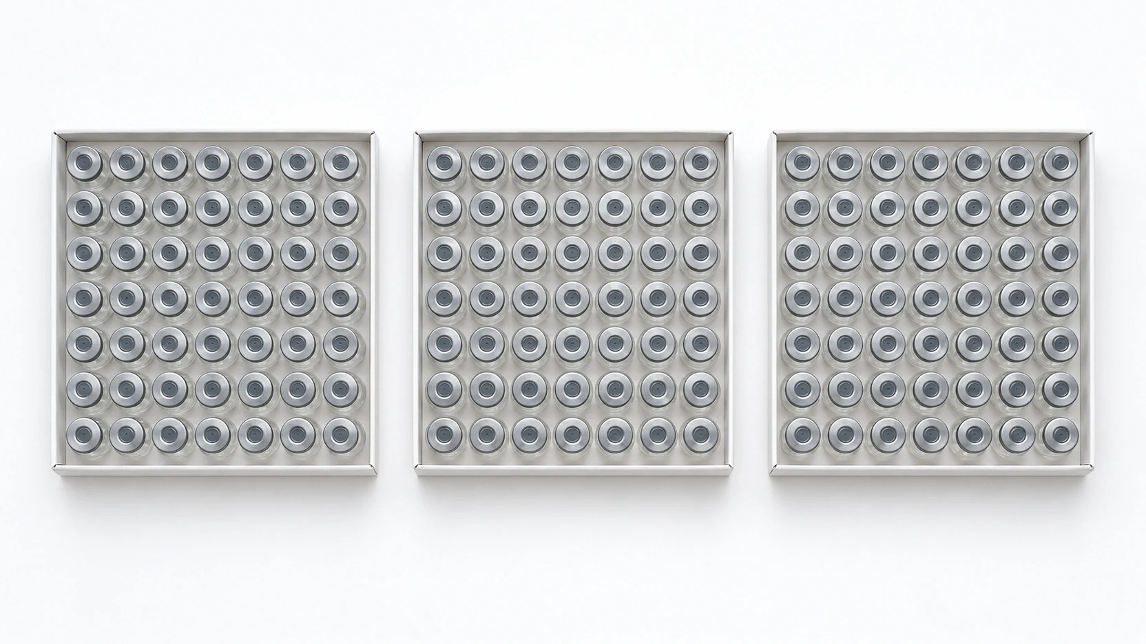 Trays of sealed vials on a plain surface